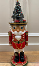LIGHTED MUSICAL ROTATING
TRAIN IN NUTCRACKER HAT